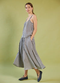 Woman wearing a Daylight Moon striped skirt and top set on a green background